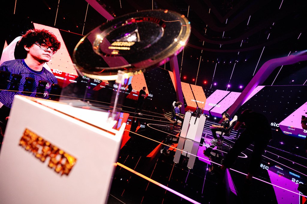 The Esports World Cup trophy on its podium under stage lighting during a final