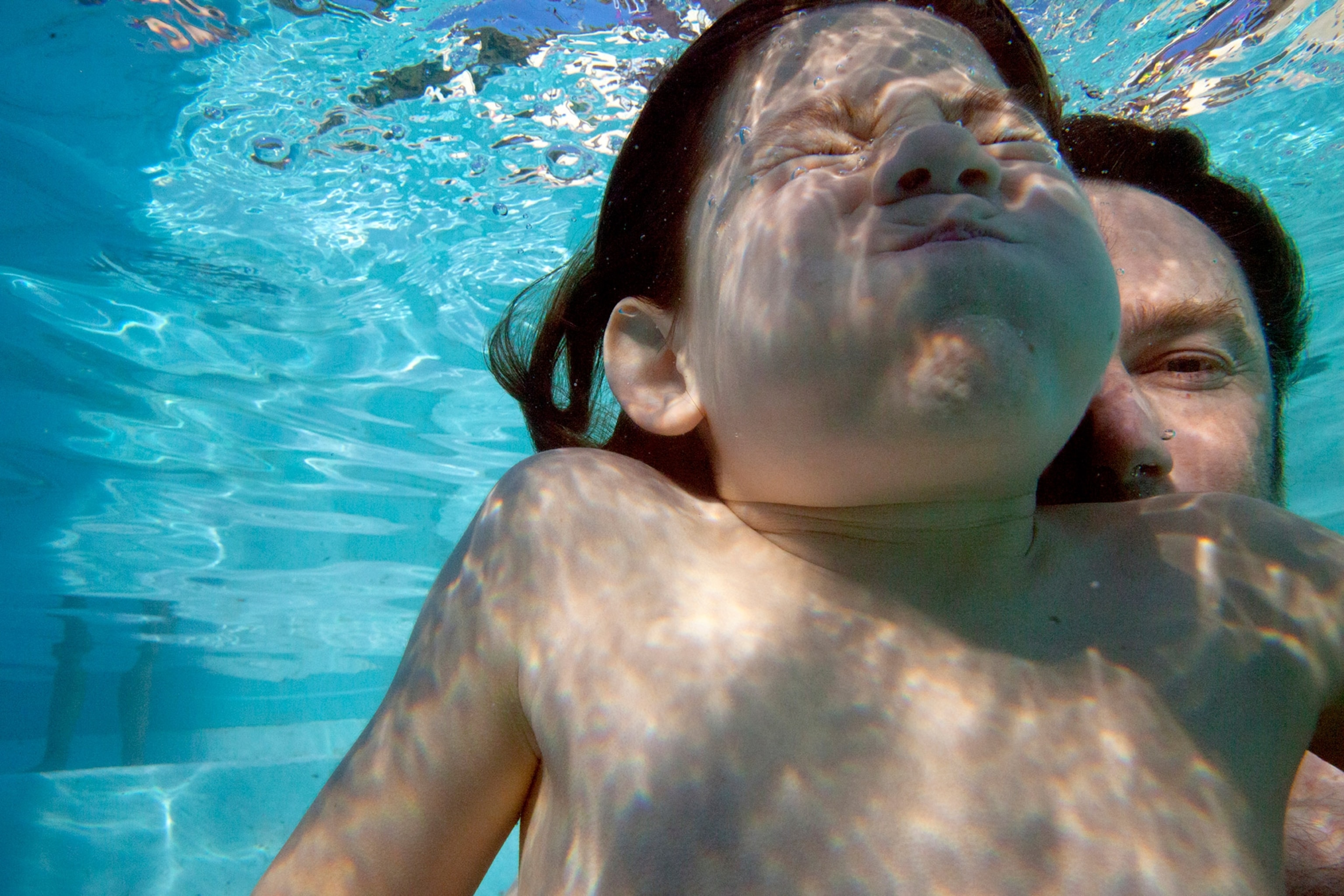 Ivan Kashinsky, father and son swimming underwater, National Geographic 2020